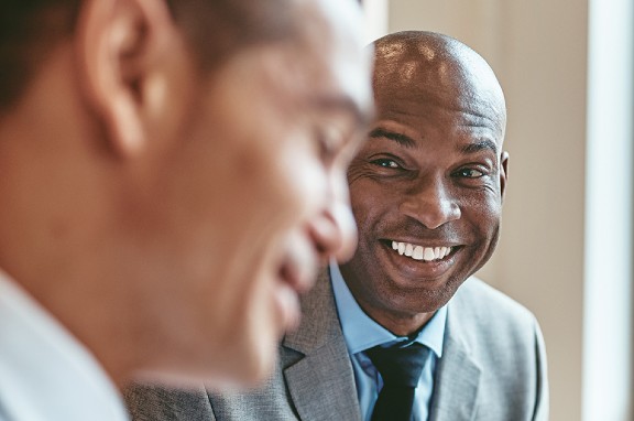 Two businessmen smiling